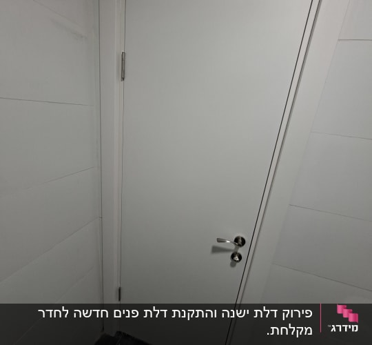 דלת לבנה עם ידית כסופה בחדר
